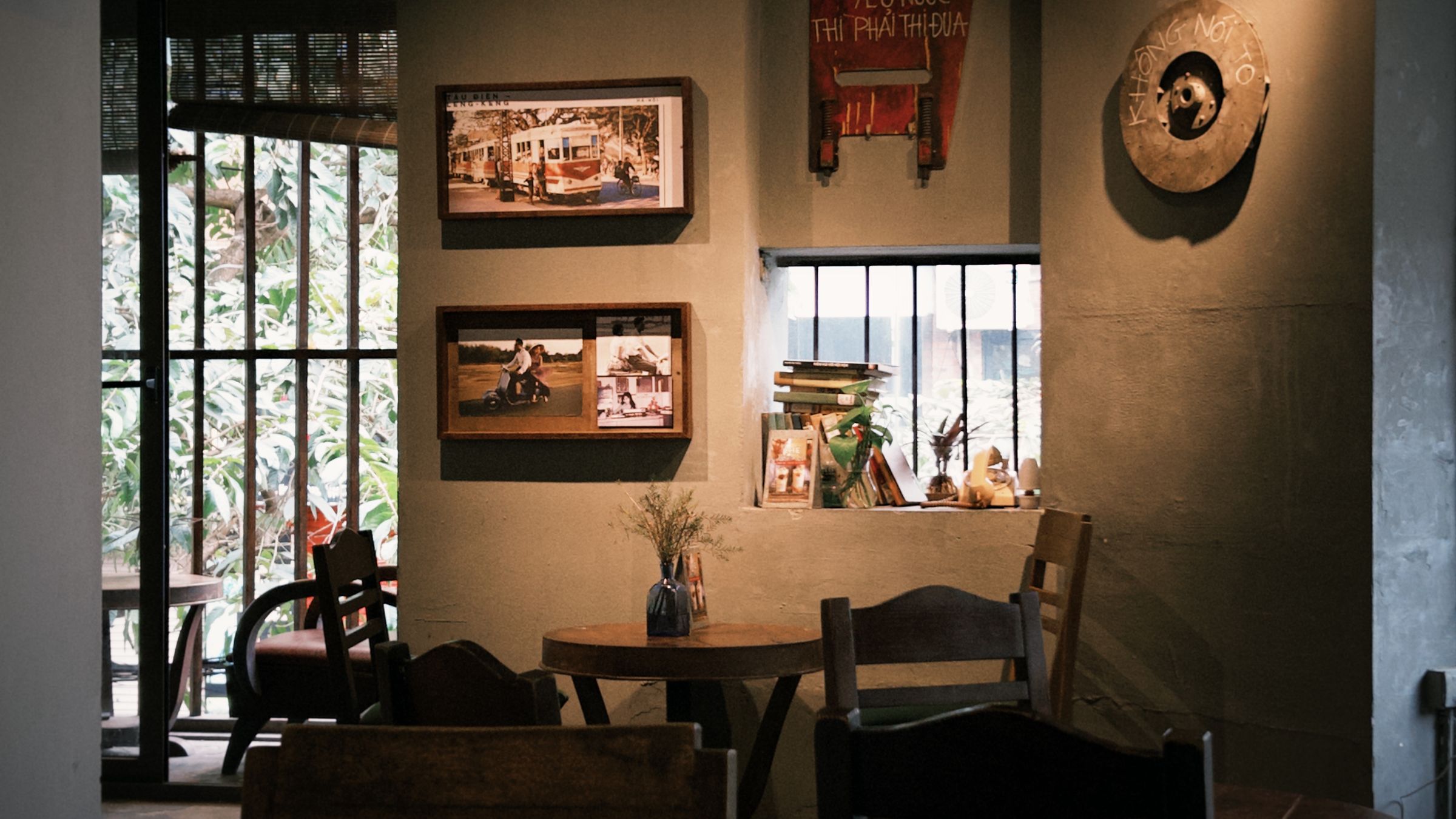 warm, sunlit interior of a small coffee shop with mismatched wooden seating